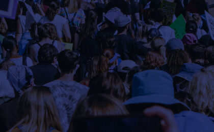 A crowd of people from behind marching together