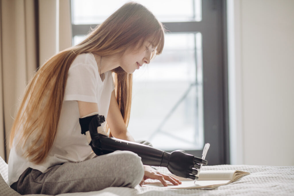 disabled female student writing a report. close up photo. copy space