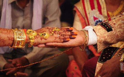 The hand of the bride held by a groom during a Indian traditional ritual in an Indian Hindu Wedding Marriage.